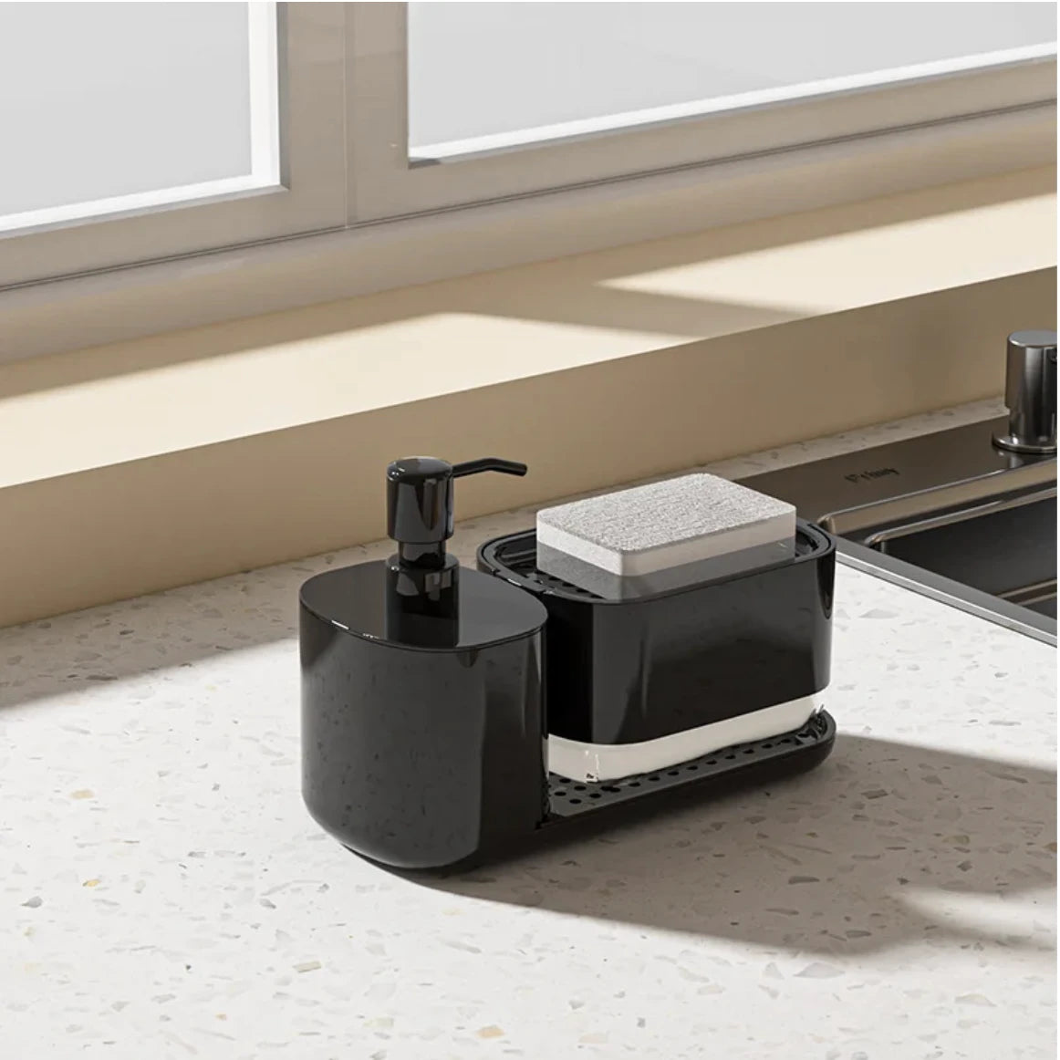 Black kitchen sink caddy with soap dispenser and sponge holder on a countertop.