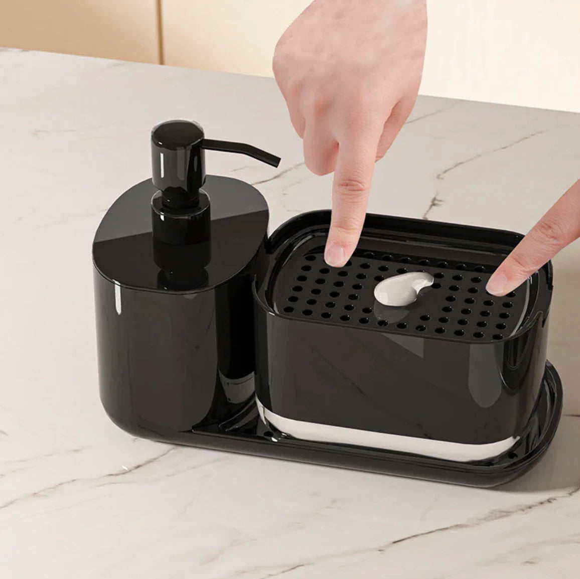 Black soap dispenser with a hand pressing a bar of soap into it on a marble surface.