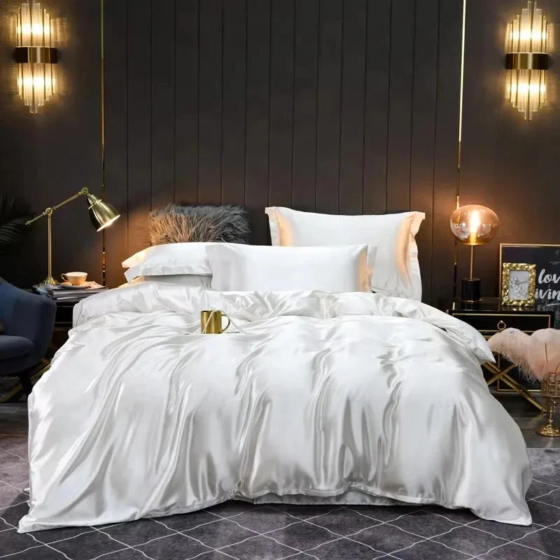 White satin comforter on a bed in a stylish bedroom with dark walls and decorative lighting.