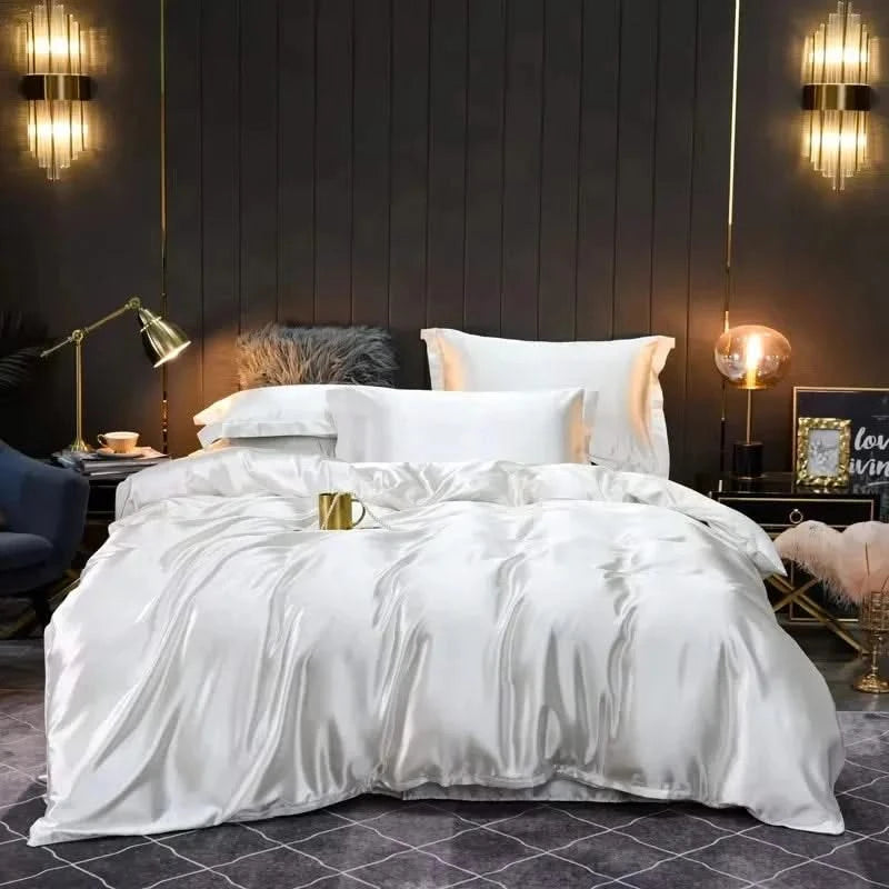 White satin comforter on a bed in a stylish bedroom with dark walls and decorative lighting.