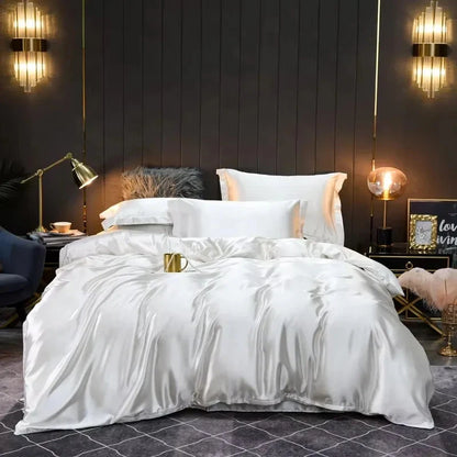 White satin comforter on a bed in a stylish bedroom with dark walls and decorative lighting.