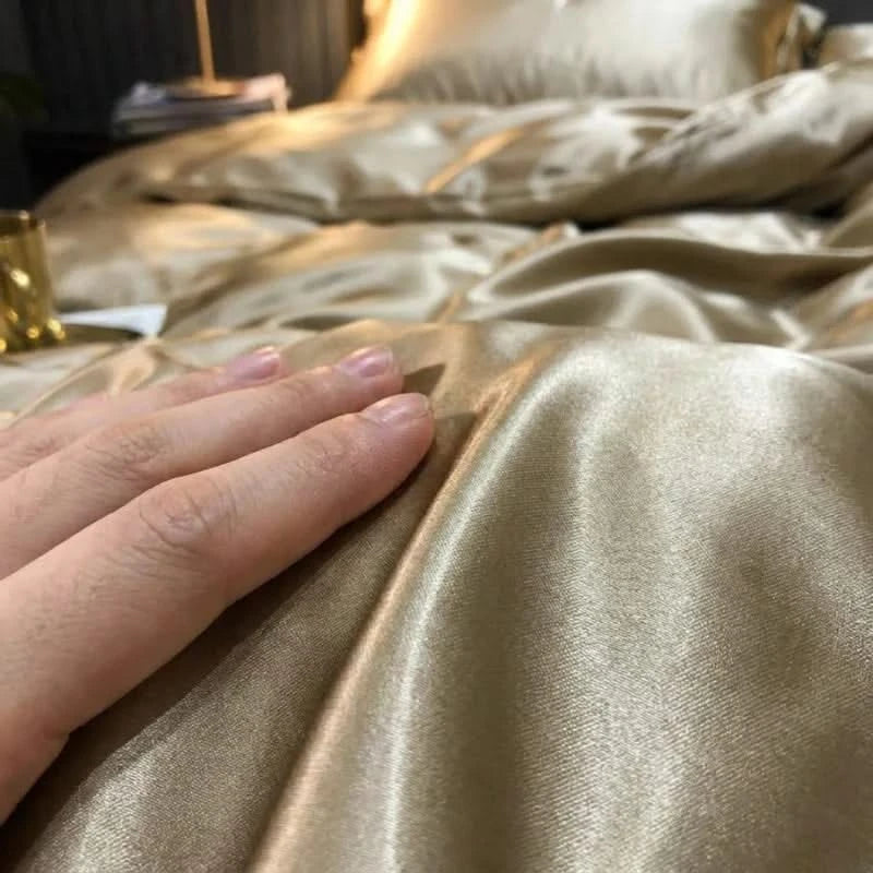Hand touching a gold satin fabric surface