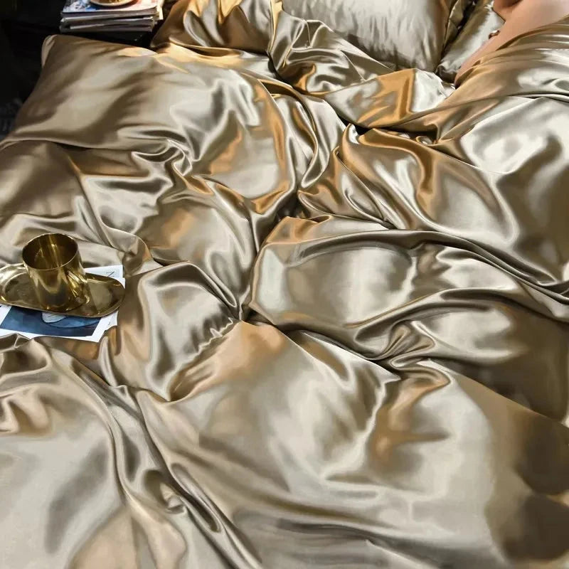 Gold satin fabric with a gold cup and paper on a dark surface