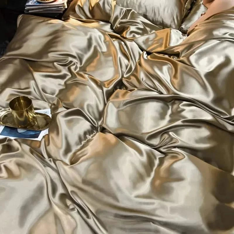 Gold satin fabric with a gold cup and paper on a dark surface