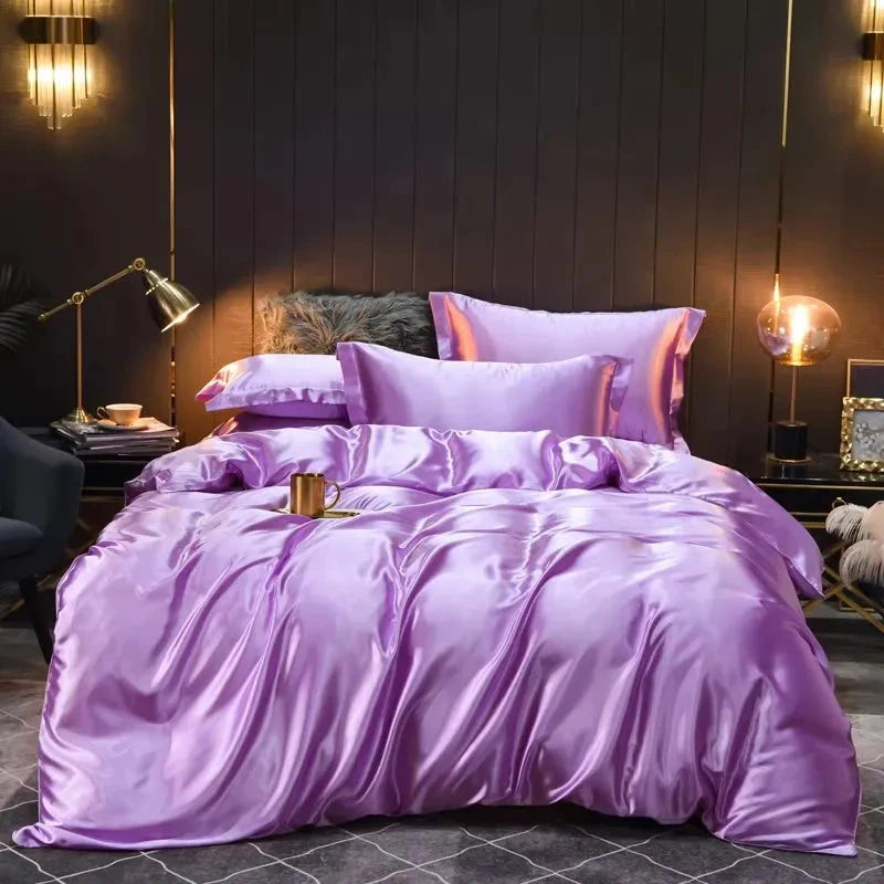 Purple bedding set on a bed in a dimly lit bedroom with decorative elements.