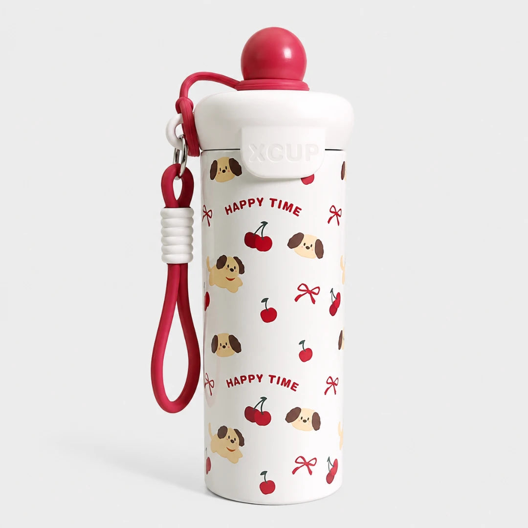 Josh & Tate - SnugPop™ Cute Insulated Tumbler - A white insulated water bottle with a red lid and matching red wrist strap, decorated with a repeating pattern of red cherries, brown-and-beige dog faces, and red bows, with the words 'HAPPY TIME' printed in red. The bottle is photographed on a clean light gray background.