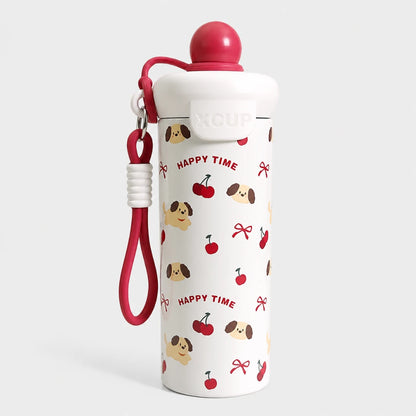Josh & Tate - SnugPop™ Cute Insulated Tumbler - A white insulated water bottle with a red lid and matching red wrist strap, decorated with a repeating pattern of red cherries, brown-and-beige dog faces, and red bows, with the words 'HAPPY TIME' printed in red. The bottle is photographed on a clean light gray background.