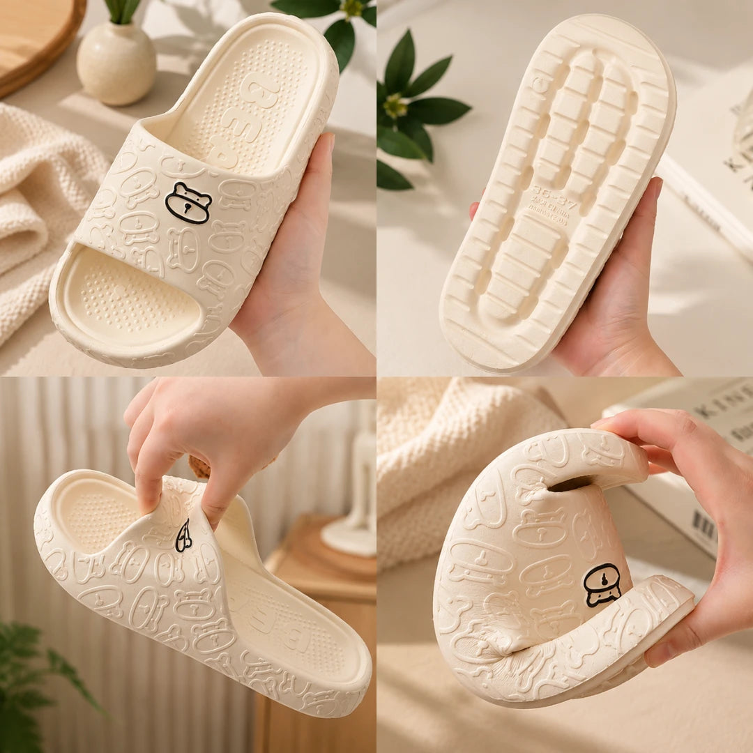 Josh & Tate - SoftBear™ Non-Slip Cushion Slides - A four-panel collage showing a pair of off-white slide sandals being held by hands to demonstrate flexibility, the side profile with a small cartoon face, the textured outsole, and the open heel. The sandals feature an embossed pattern and a small black cartoon face on the strap.