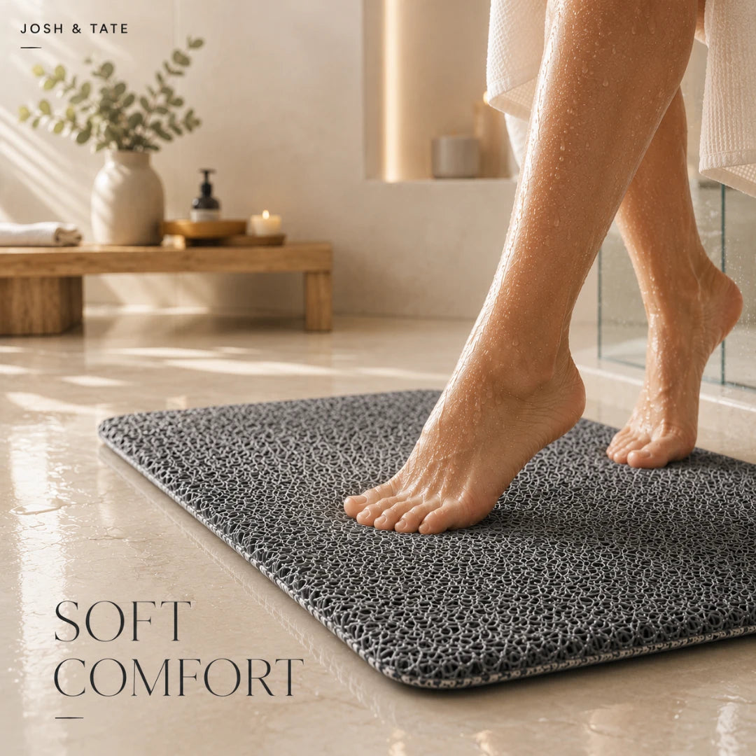 Josh & Tate - SoftStep™ Anti-Slip Bath Mat - Person stepping onto a textured bath mat in a bathroom setting with 'Josh & Tate' branding.
