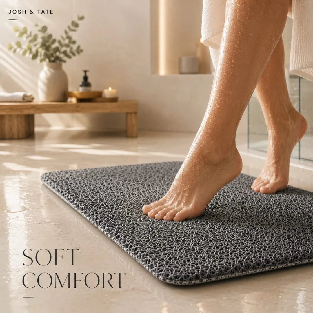 Josh & Tate - SoftStep™ Anti-Slip Bath Mat - Person stepping onto a textured bath mat in a bathroom setting with 'Josh & Tate' branding.