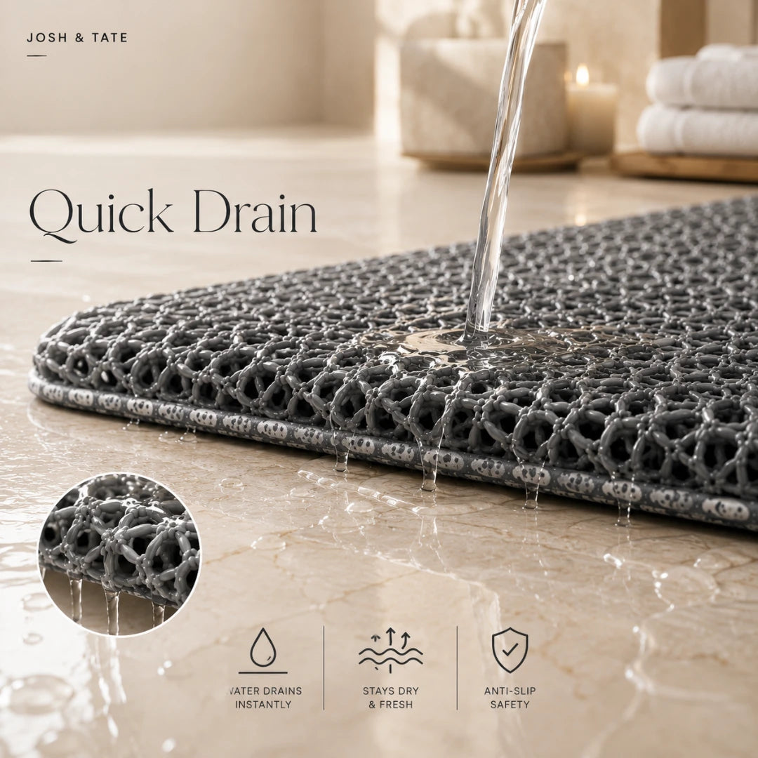 Josh & Tate - SoftStep™ Anti-Slip Bath Mat - Gray bath mat with water draining feature on a bathroom floor, featuring Josh & Tate brand.