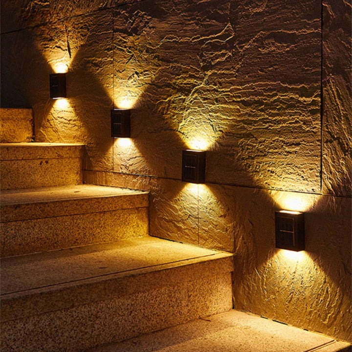Josh & Tate - SolarGlow Wireless Wall Lamp - Staircase with wall-mounted lights on a stone wall