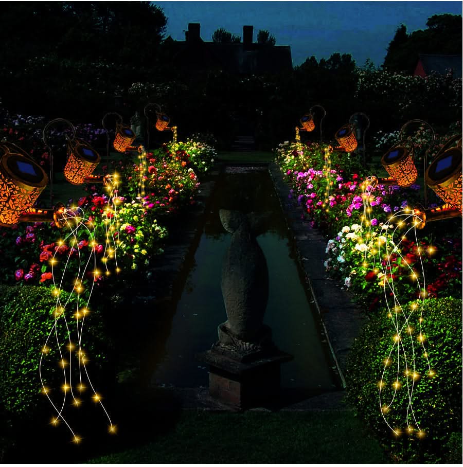 Garden scene with string lights, flowers, and a statue at night.