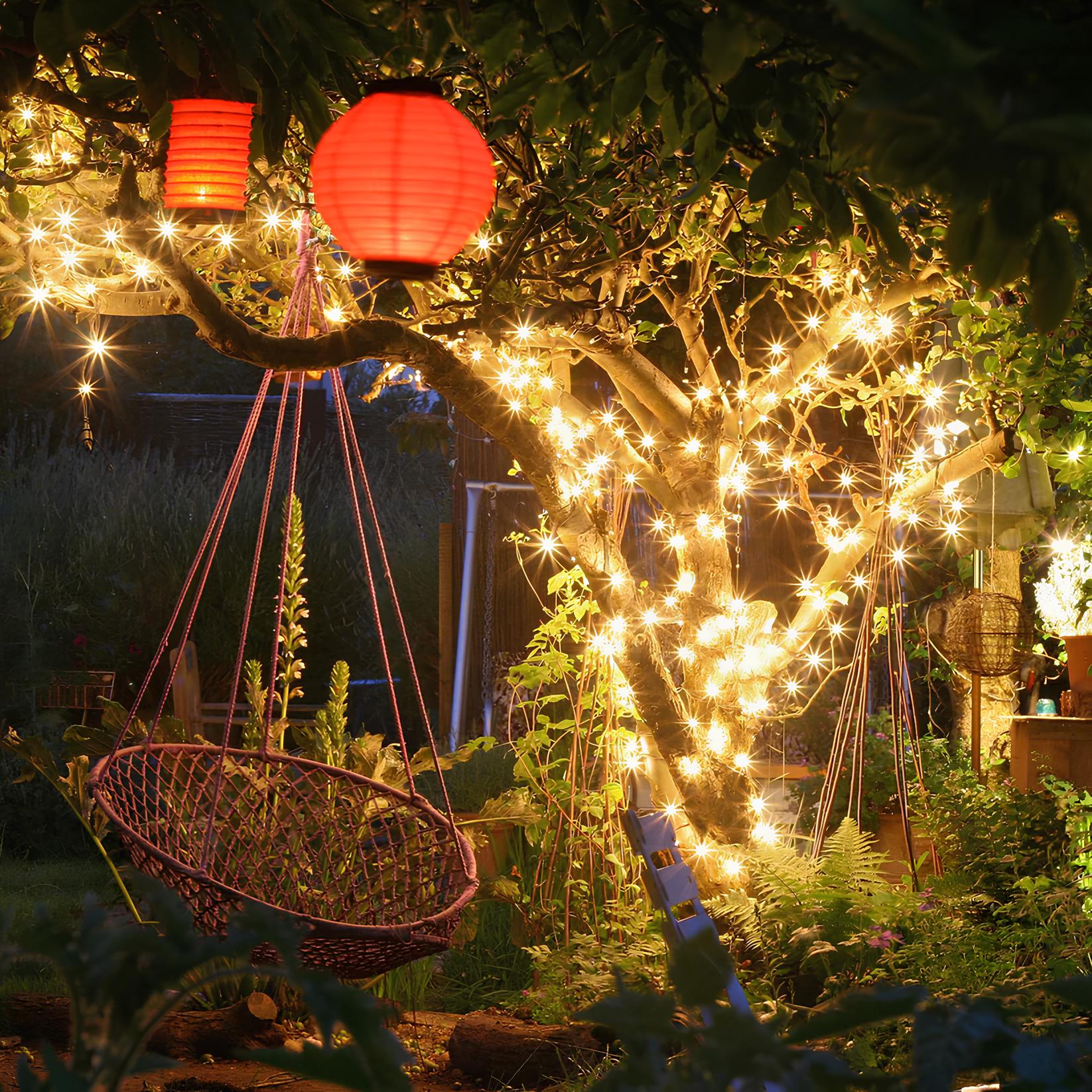 Garden scene with hanging basket, red lanterns, and string lights under a tree