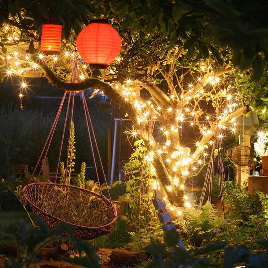 Garden scene with hanging basket, red lanterns, and string lights under a tree