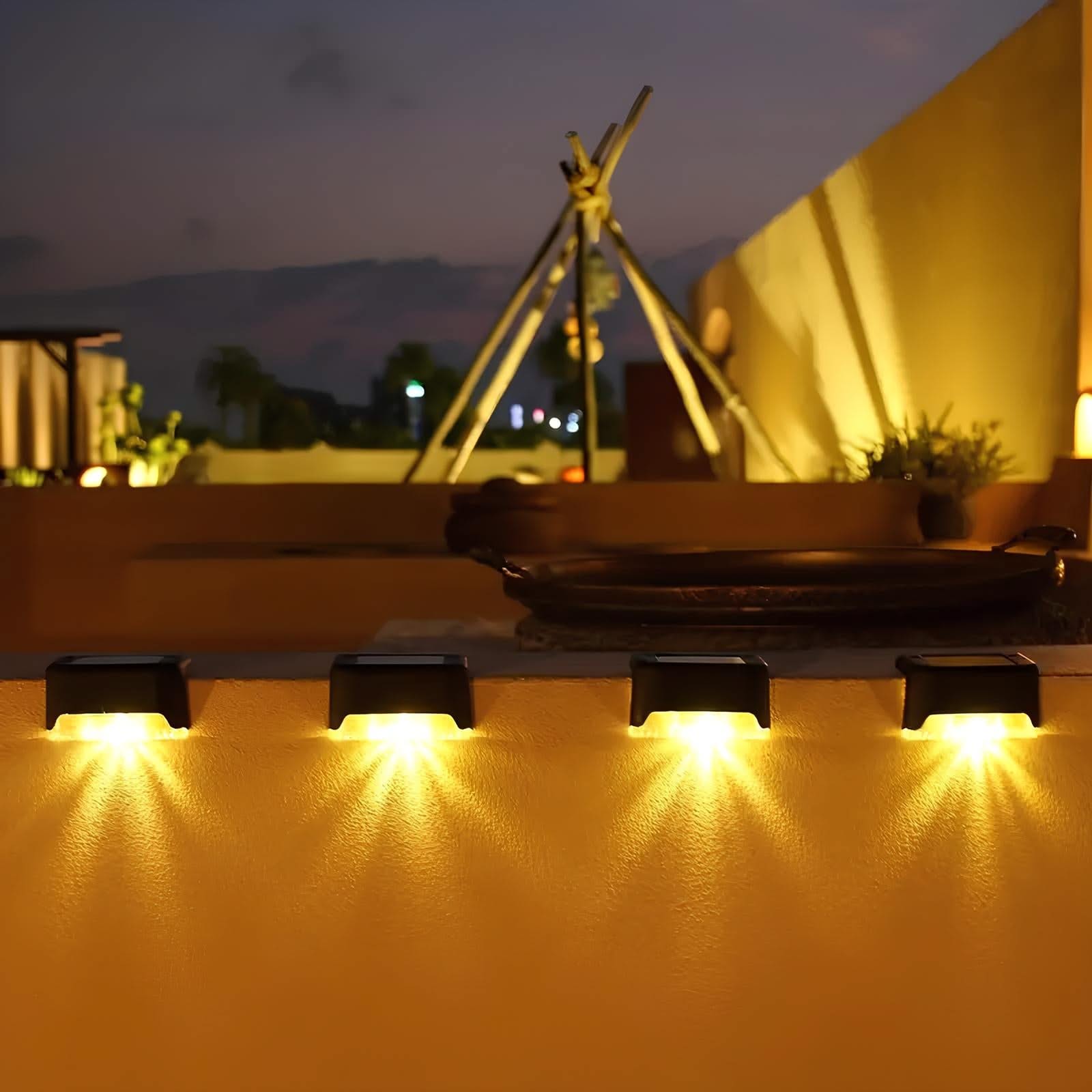 Solar-powered deck lights on a patio with a tent and outdoor furniture in the background.