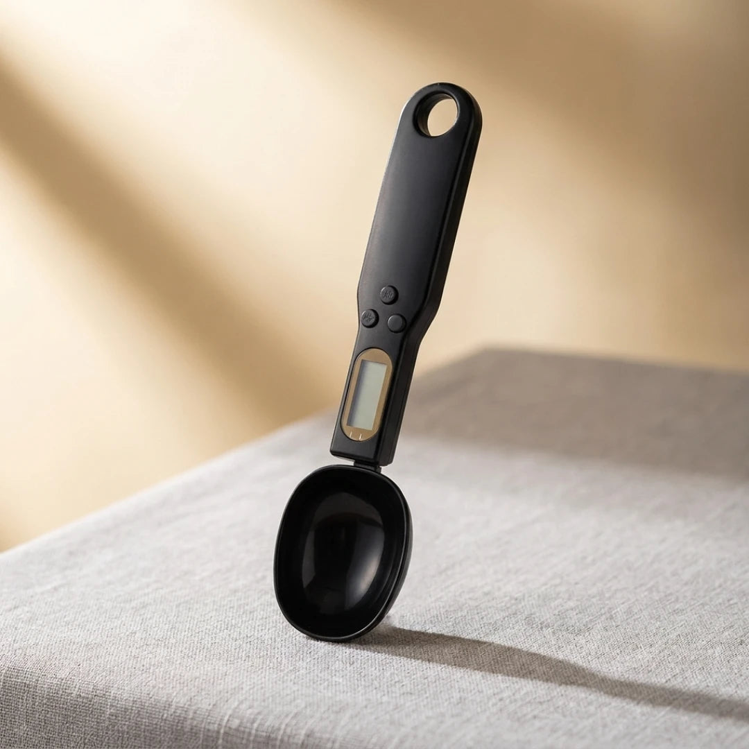 Josh & Tate - SpoonScale™ Smart Measuring Spoon -Black digital measuring spoon on a textured surface with a neutral background