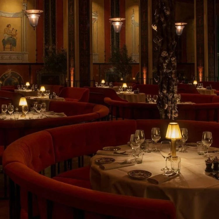 Dining area with red chairs and lit lamps in a restaurant setting