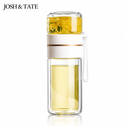 Josh & Tate - SteepSeal™ Tea-Water Separation Bottle - Glass water bottle with a white lid aand handle, filled with yellow liquid, on a white background. Brand 'JOSH & TATE' visible.