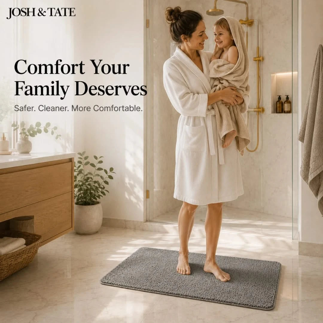 Josh & Tate - StepDry™ Anti-Slip Bath Mat - Woman in a white robe holding a child in a bathroom with 'Josh & Tate' branding.
