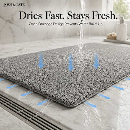 Josh & Tate - StepDry™ Anti-Slip Bath Mat - Gray bath mat with water drainage design on a bathroom floor, featuring Josh & Tate branding.