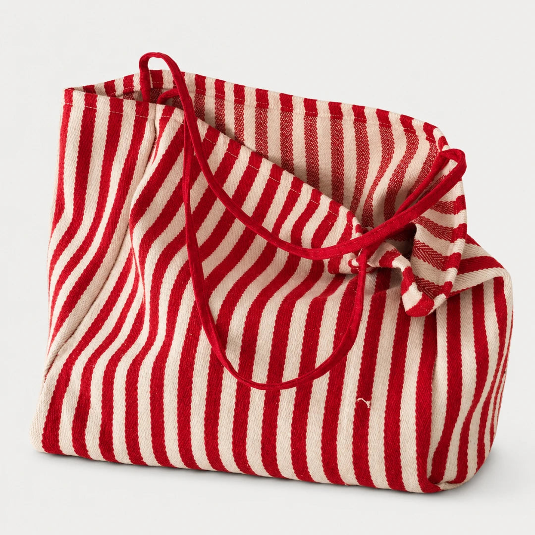 Josh & Tate - StripeCarry™ Oversized Tote Bag - A red and off-white vertically striped fabric tote bag with red rope handles, shown on a clean light gray background.