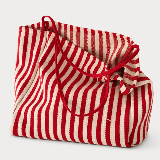 Josh & Tate - StripeCarry™ Oversized Tote Bag - A red and off-white vertically striped fabric tote bag with red rope handles, shown on a clean light gray background.