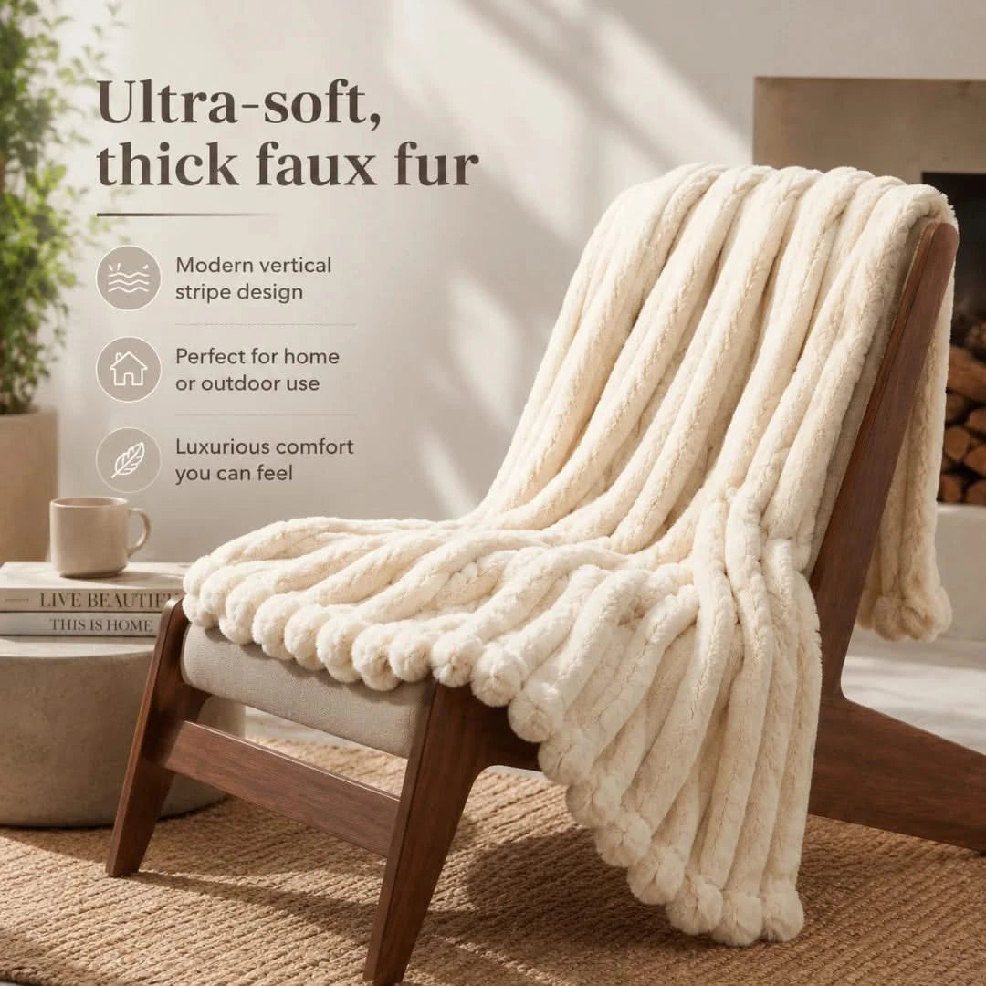 Beige faux fur throw blanket draped over a wooden chair in a cozy living room setting.