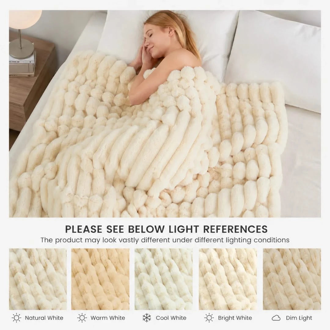 Woman sleeping under a textured beige blanket in a bedroom setting.