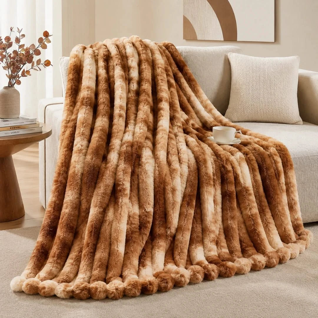 Brown fur throw blanket draped over a sofa in a living room setting.