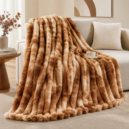 Brown fur throw blanket draped over a sofa in a living room setting.