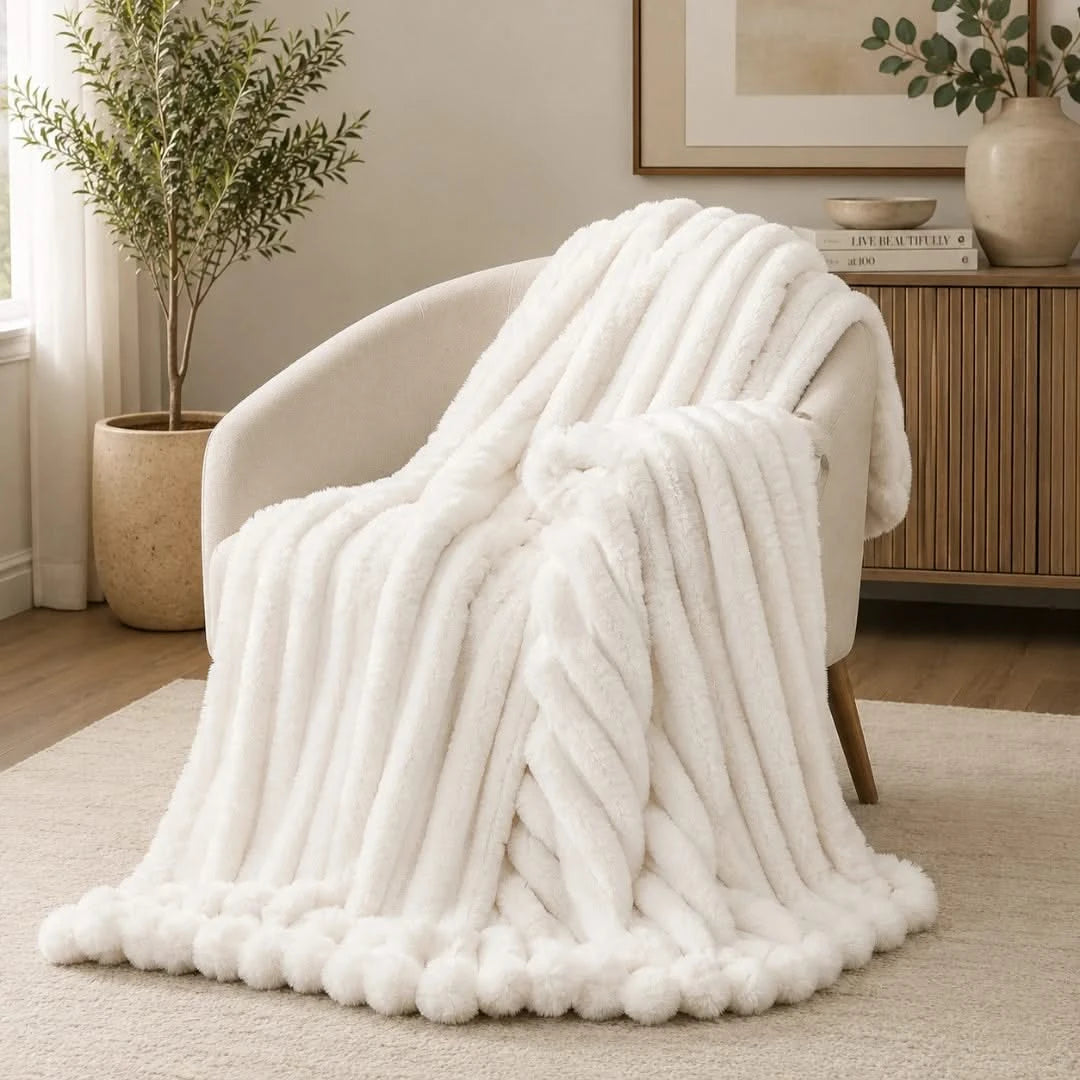 White textured blanket draped over a chair in a cozy living room.
