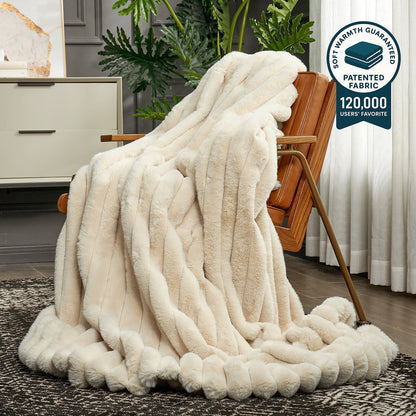 White fluffy blanket draped over a chair in a room with plants and furniture.