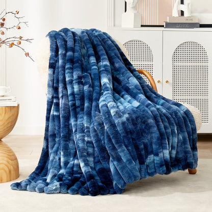 Blue textured blanket draped over a chair in a room with a cabinet and decorative items.