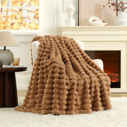 Brown textured blanket draped over a chair in a cozy living room with a fireplace.