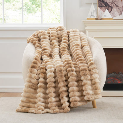 Beige fuzzy blanket draped over a chair in a cozy living room.