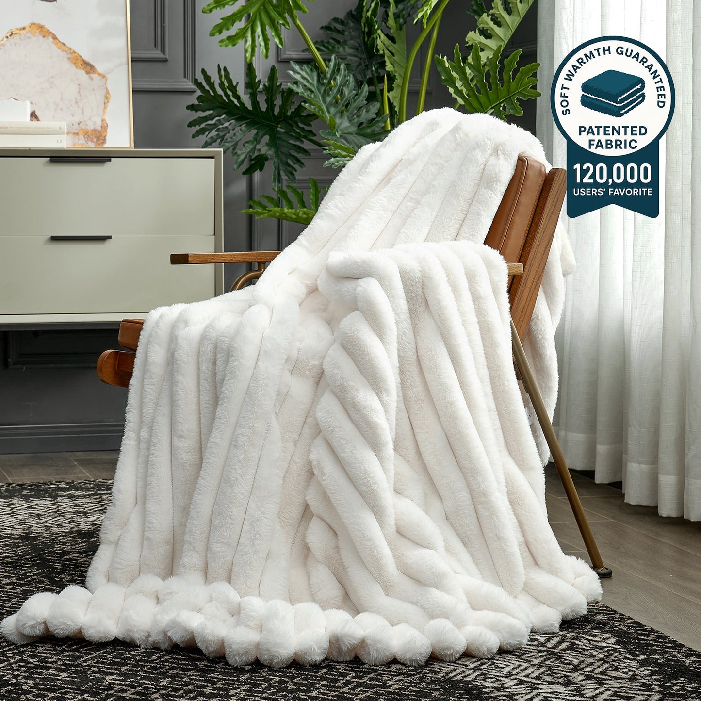 White fleece blanket draped over a wooden chair in a room with plants and furniture.