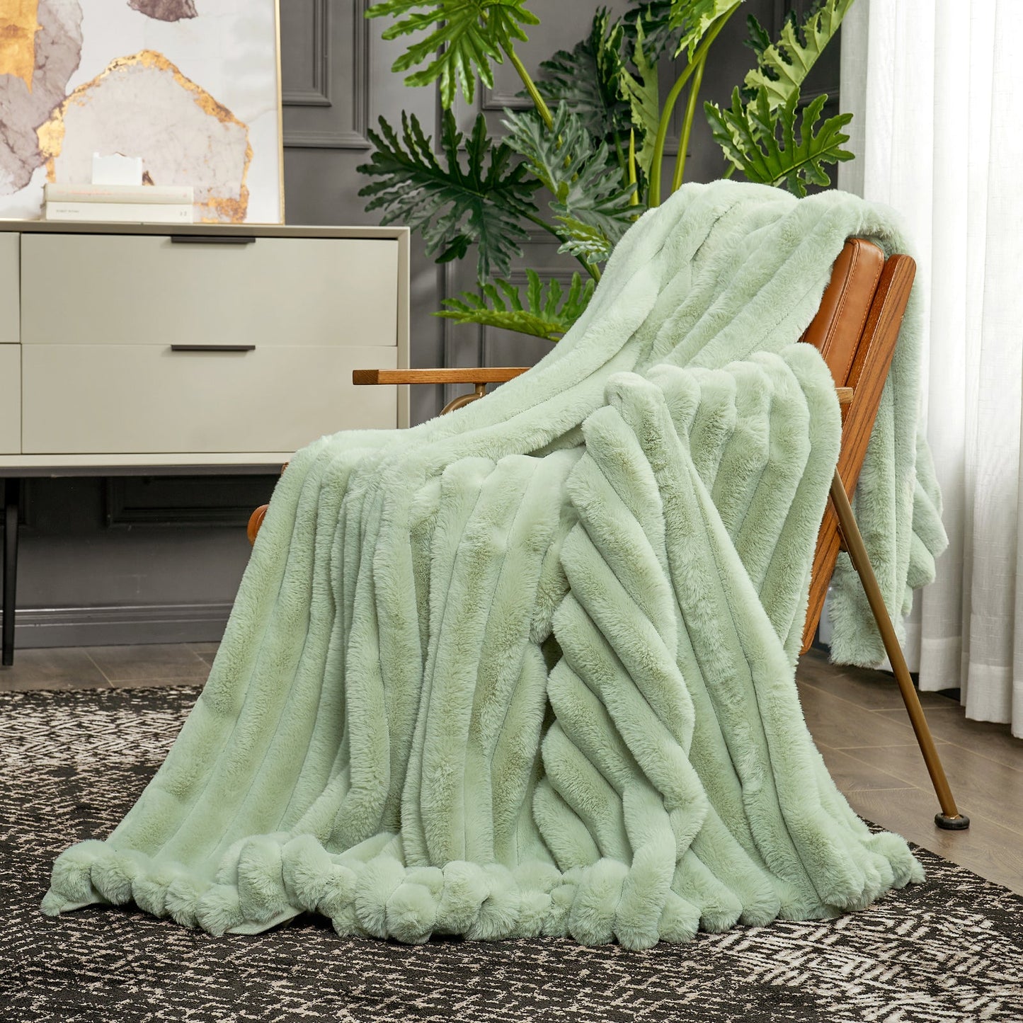 Light green blanket draped over a wooden chair in a room with plants and furniture.