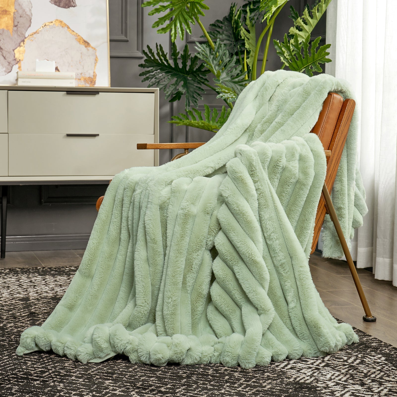 Light green blanket draped over a wooden chair in a room with plants and furniture.