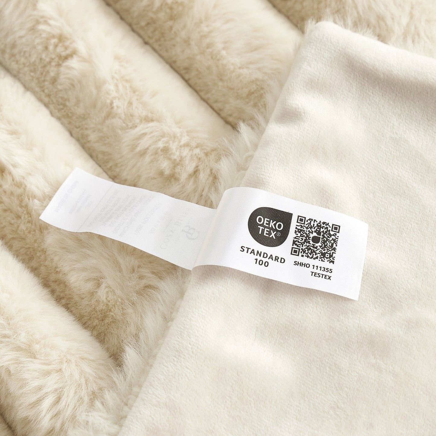 Beige fabric with an OEKO-TEX label on a close-up view