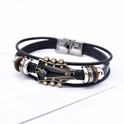 Black leather bracelet with guitar pick and music note design on a white background