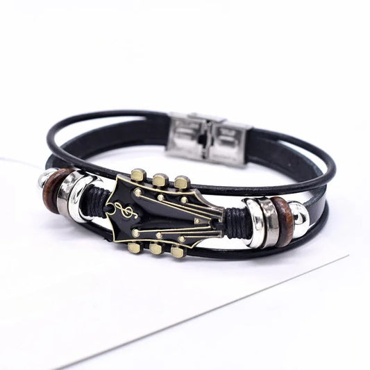 Black leather bracelet with guitar pick and music note design on a white background
