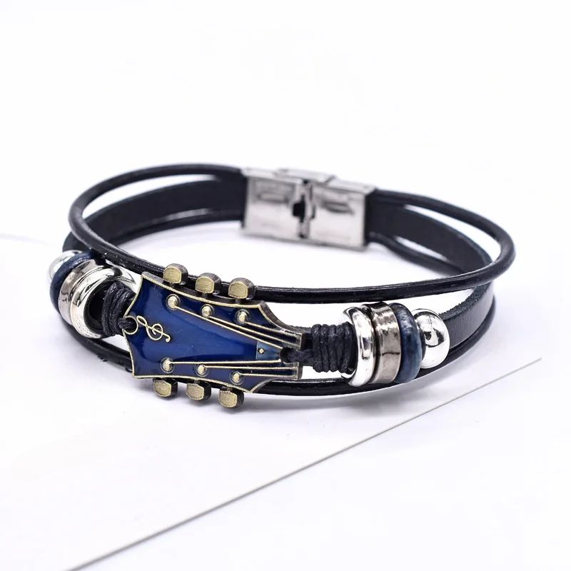 Black leather bracelet with blue guitar-shaped charm on a white background