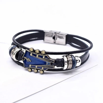 Black leather bracelet with blue guitar-shaped charm on a white background