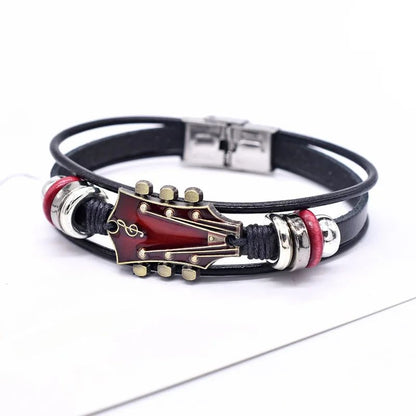 Black leather bracelet with guitar-shaped clasp on a white background