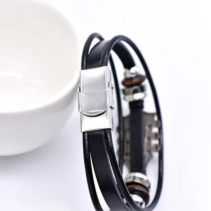 Black leather bracelet with silver clasp on a white background