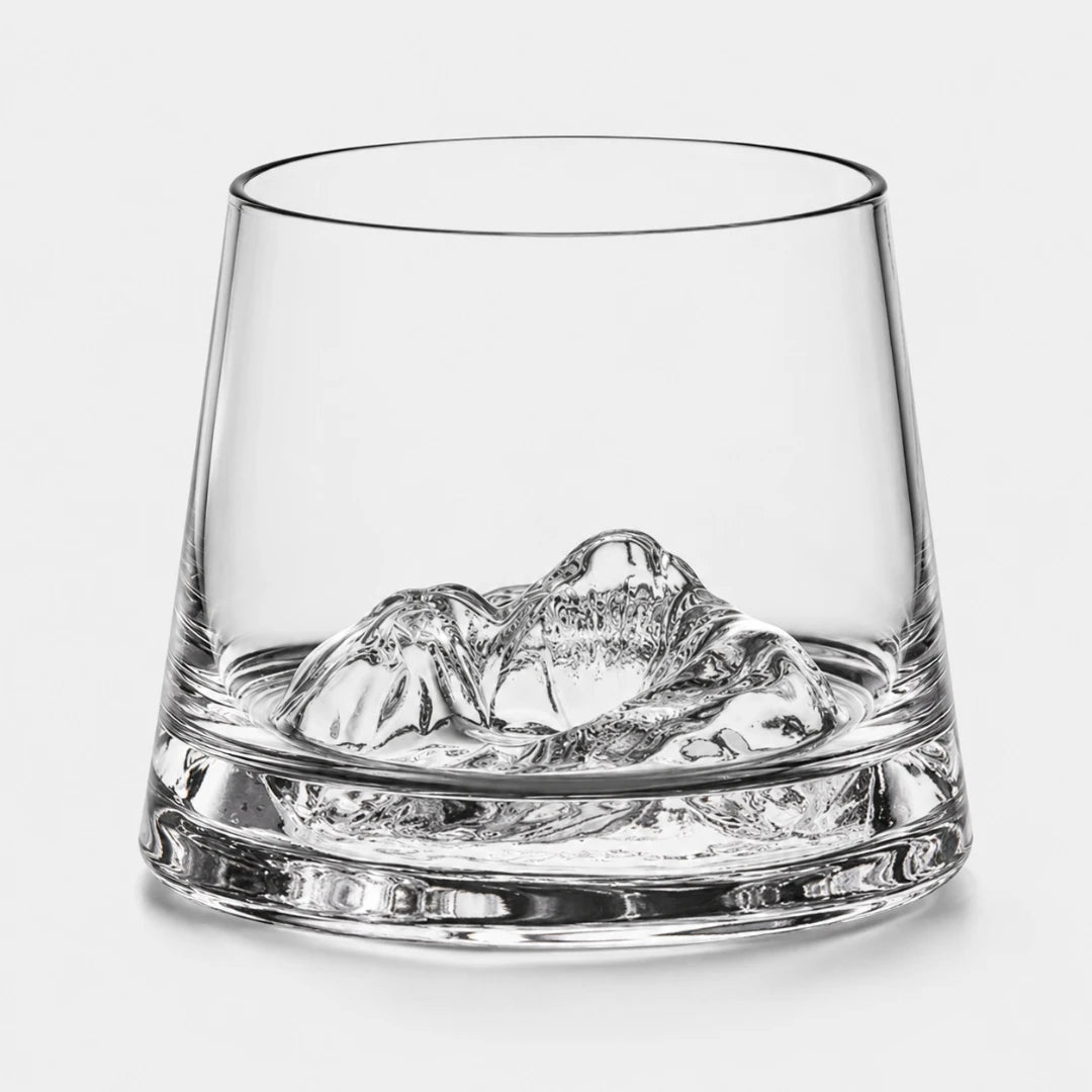 Josh & Tate - SummitRock™ Crystal Whiskey Glass - A clear glass rocks tumbler with a sculpted mountain-shaped ice piece inside, photographed on a clean light gray background.