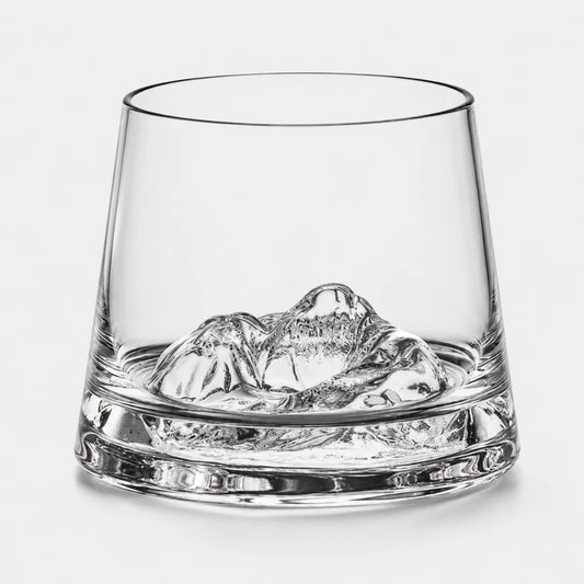 Josh & Tate - SummitRock™ Crystal Whiskey Glass - A clear glass rocks tumbler with a sculpted mountain-shaped ice piece inside, photographed on a clean light gray background.