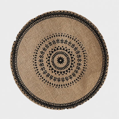 Josh & Tate - SunWeave™ Boho Mandala Placemat - A round natural jute rug with a black geometric mandala pattern and a decorative braided border, shown from a top-down view on a light gray background.