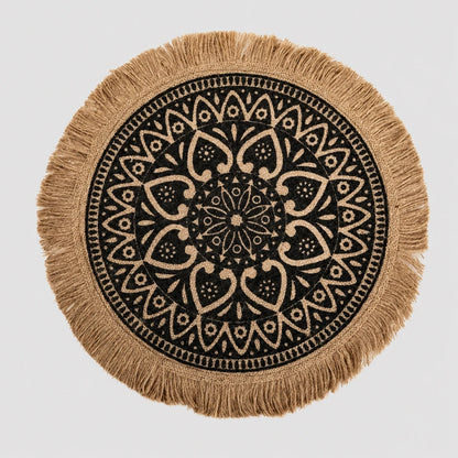 Josh & Tate - SunWeave™ Boho Mandala Placemat - Round woven throw pillow cover with a black and beige mandala pattern and fringed edges, shown on a light gray background.
